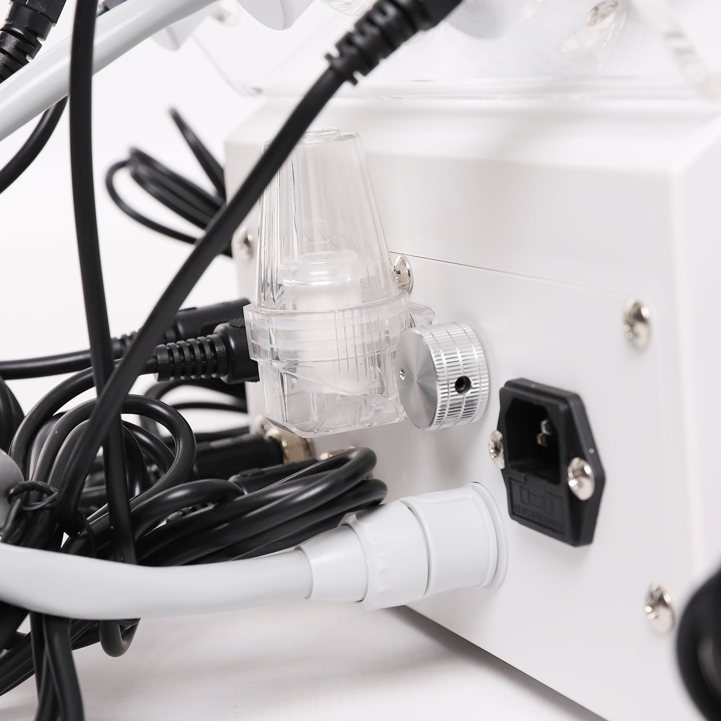 Close-up of a power strip with multiple cables plugged into it on a white background