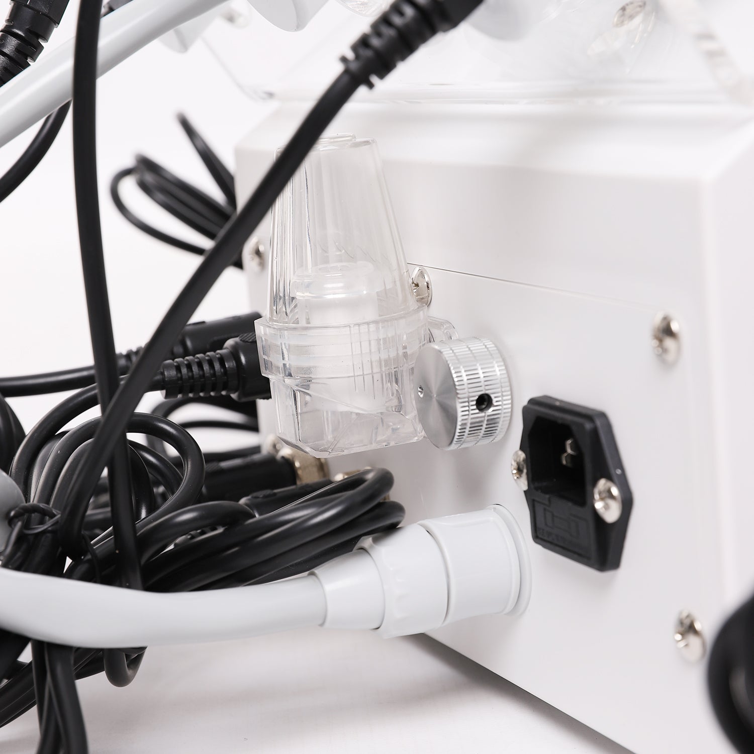 Close-up of a power strip with multiple cables plugged into it on a white background