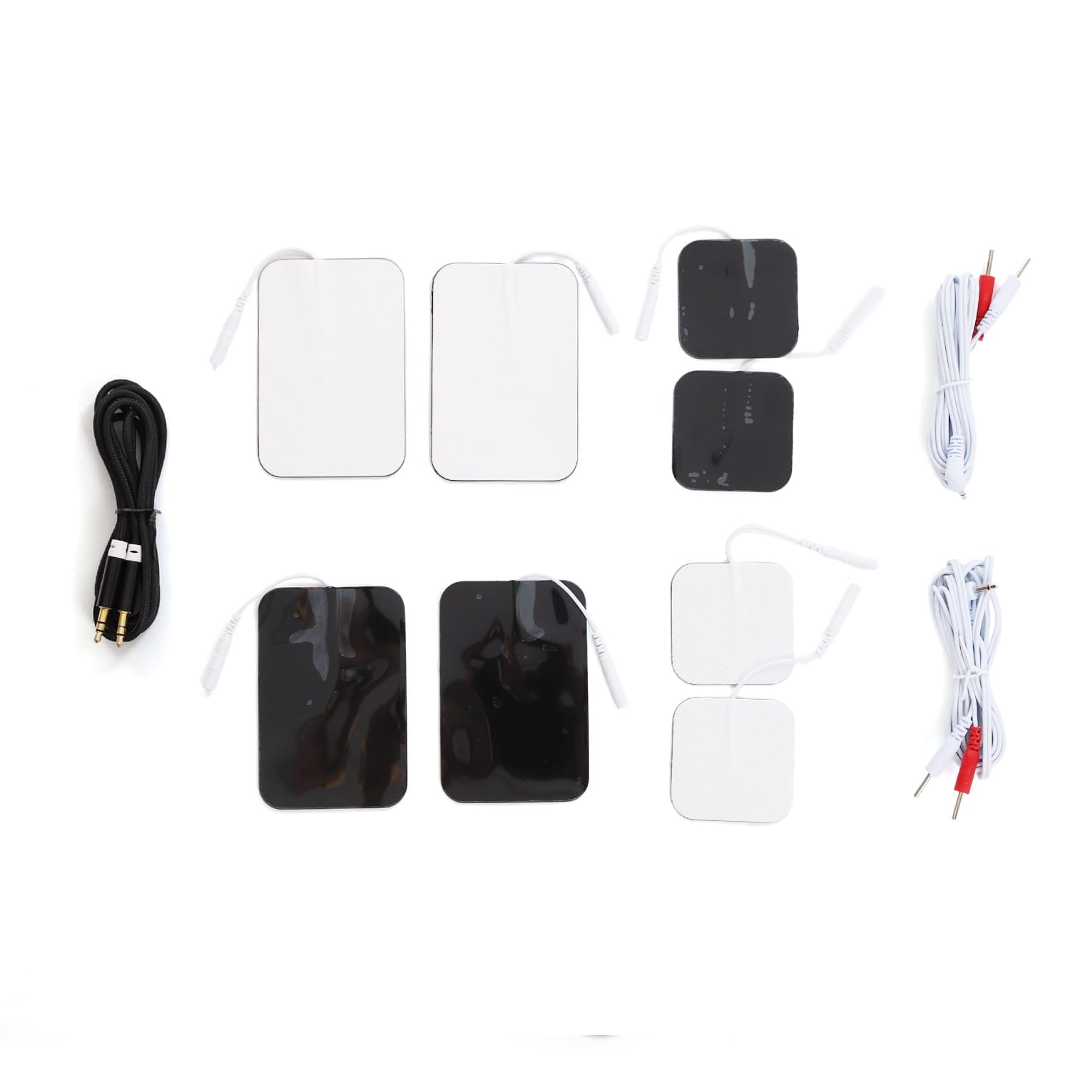 Electrode pad set with assorted black and white pads, connector cables, and dual-pin wires for therapy devices.