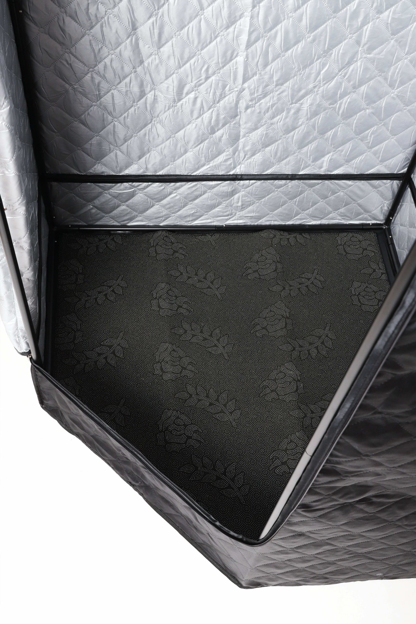 Close-up of the sauna tent’s patterned interior floor.