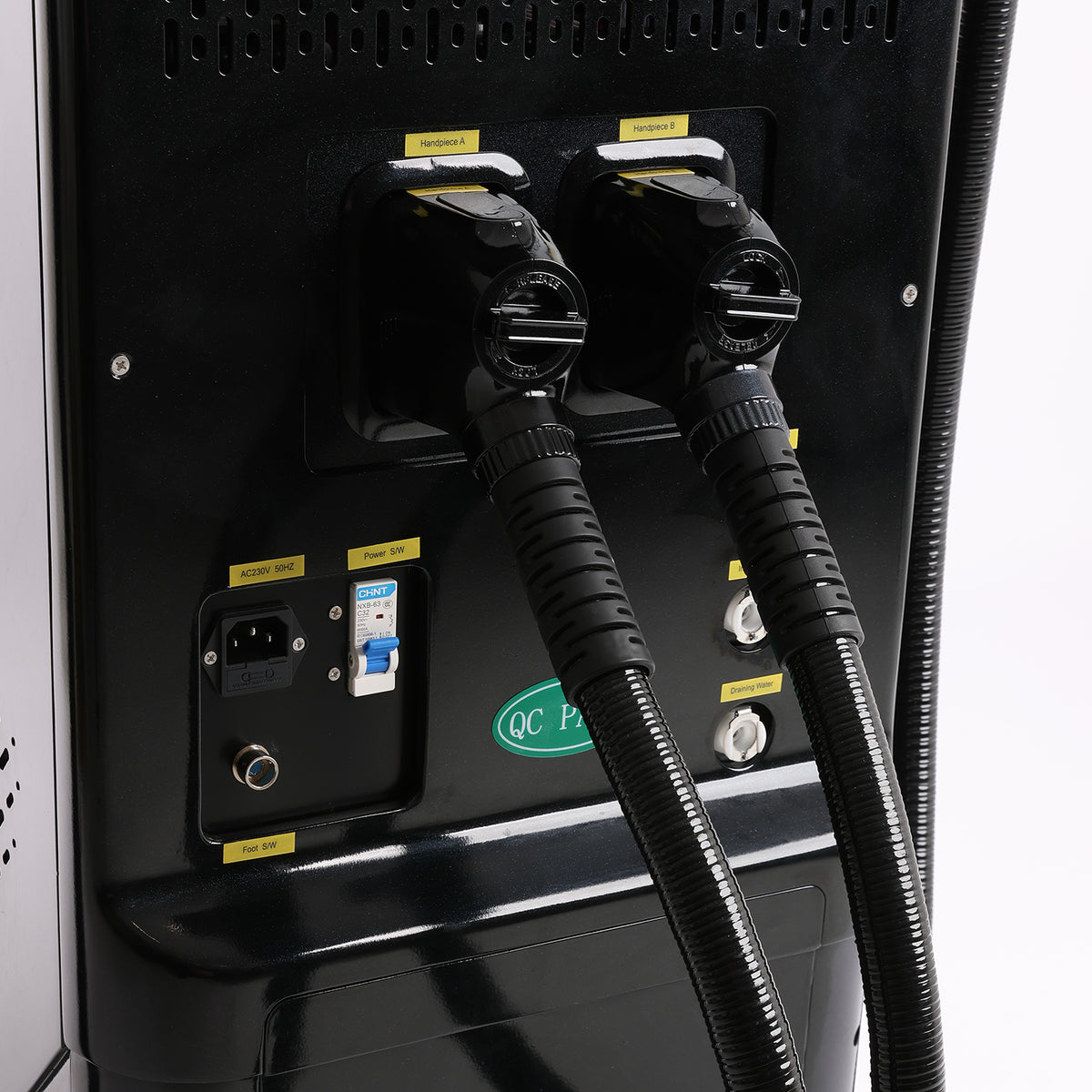 Close-up of the rear electrical and connection panel of a black industrial machine,