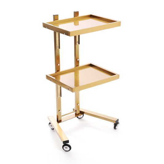 A two-tier gold metal serving cart with trays and black caster wheels.