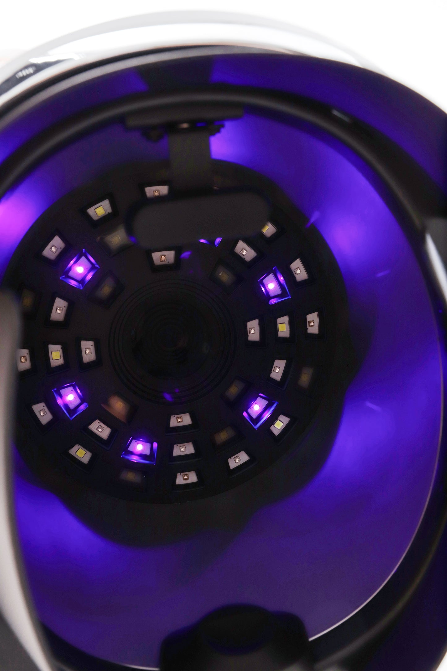 Inside view of AI facial imaging device with active purple diagnostic LED lights for skin assessment