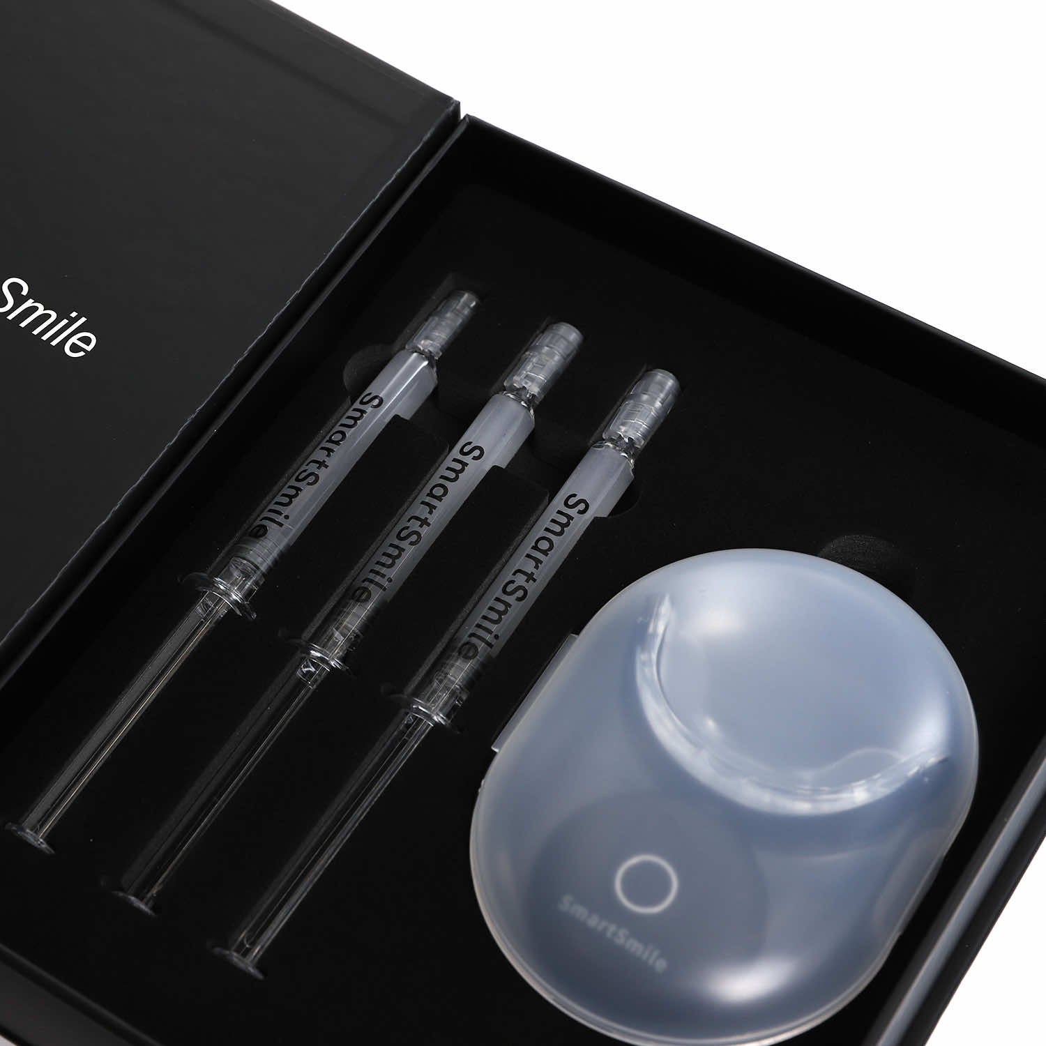 SmartSmile LED tray and three whitening syringes arranged neatly in foam tray.