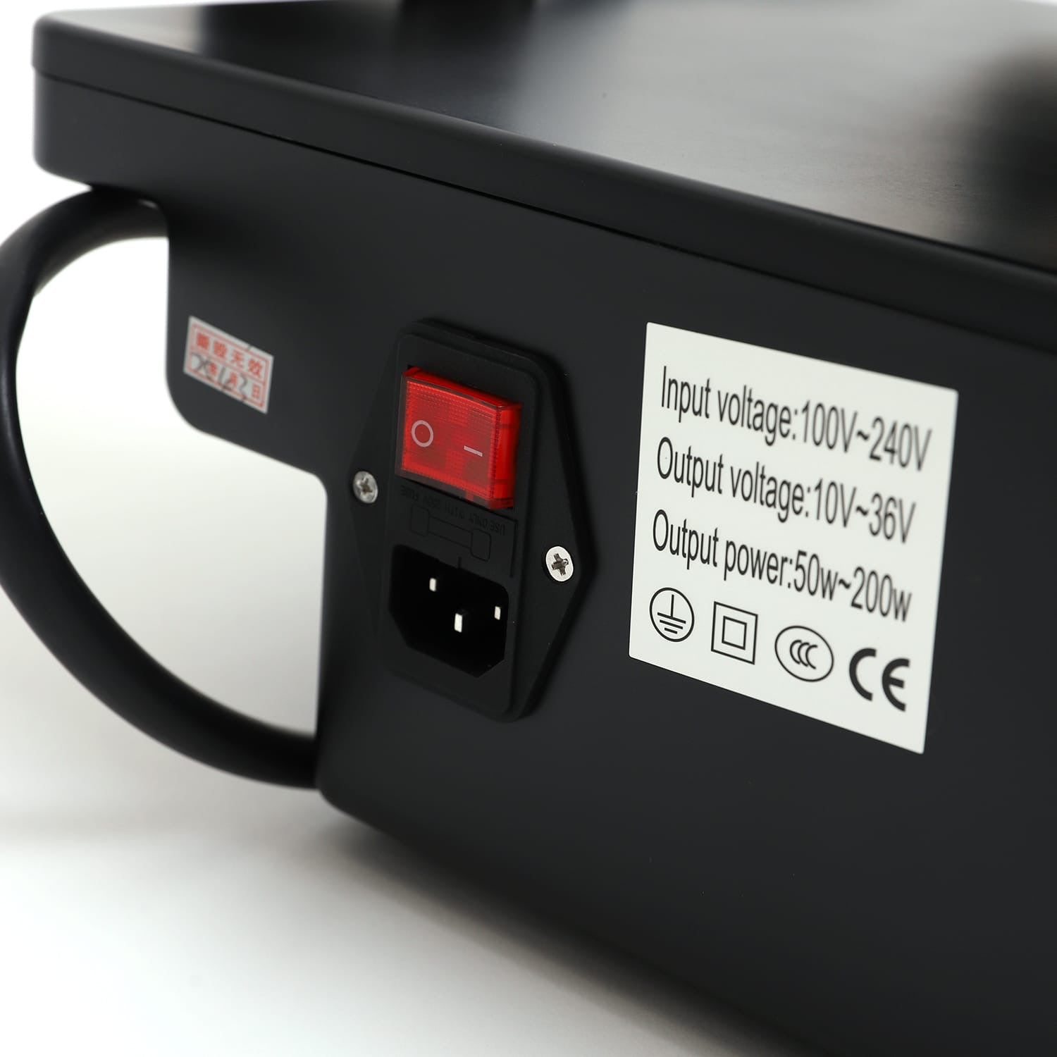 Close-up of RF microneedling device power switch and label showing input/output voltage and power specifications.