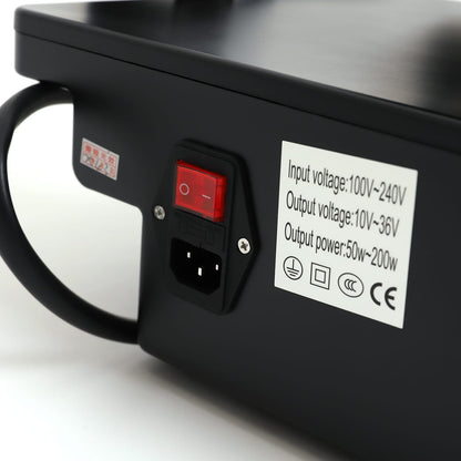 Close-up of RF microneedling device power switch and label showing input/output voltage and power specifications.