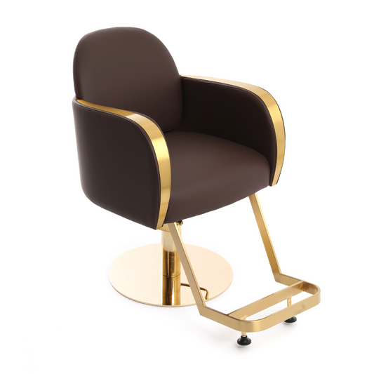 A modern salon barber chair with dark brown faux leather upholstery and polished gold metal accents,