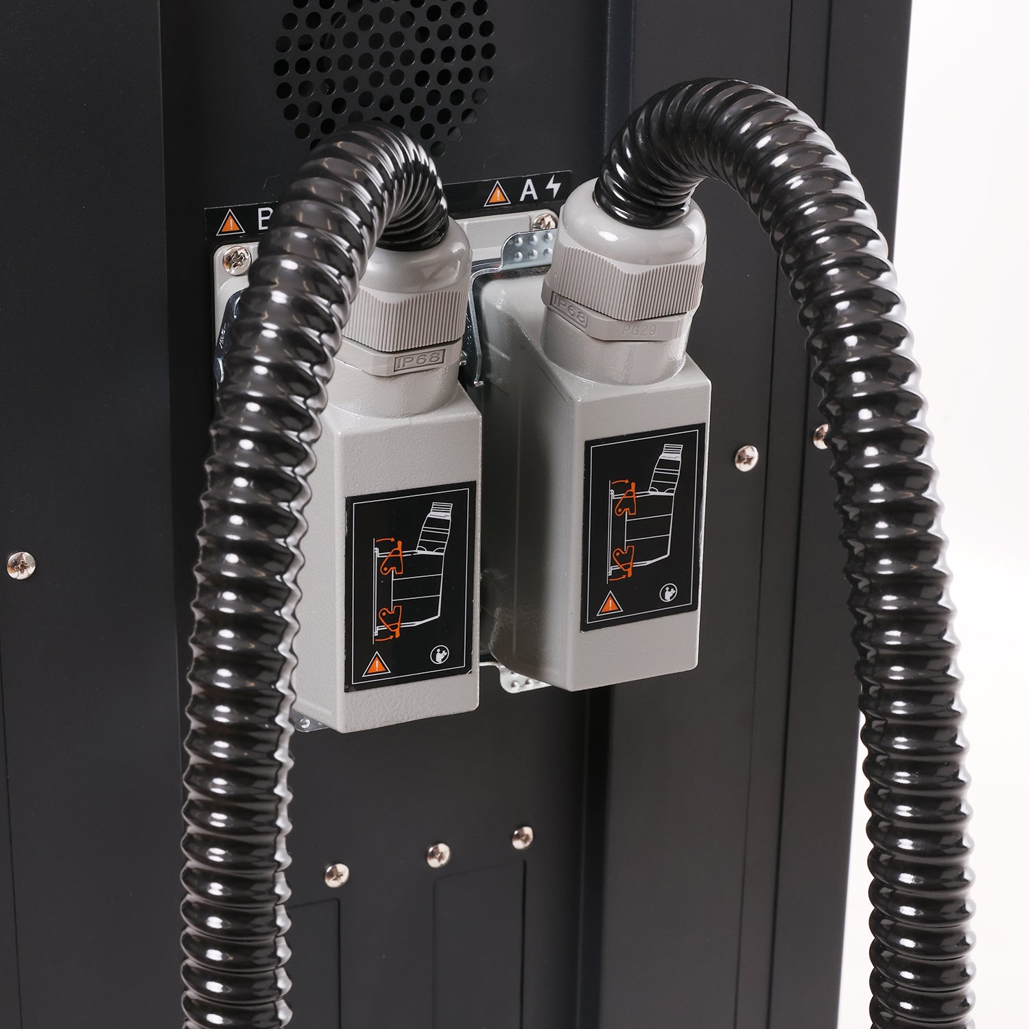 Close-up of a machine with black hoses and control panels on a white background