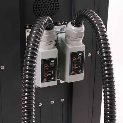 Close-up of a machine with black hoses and control panels on a white background