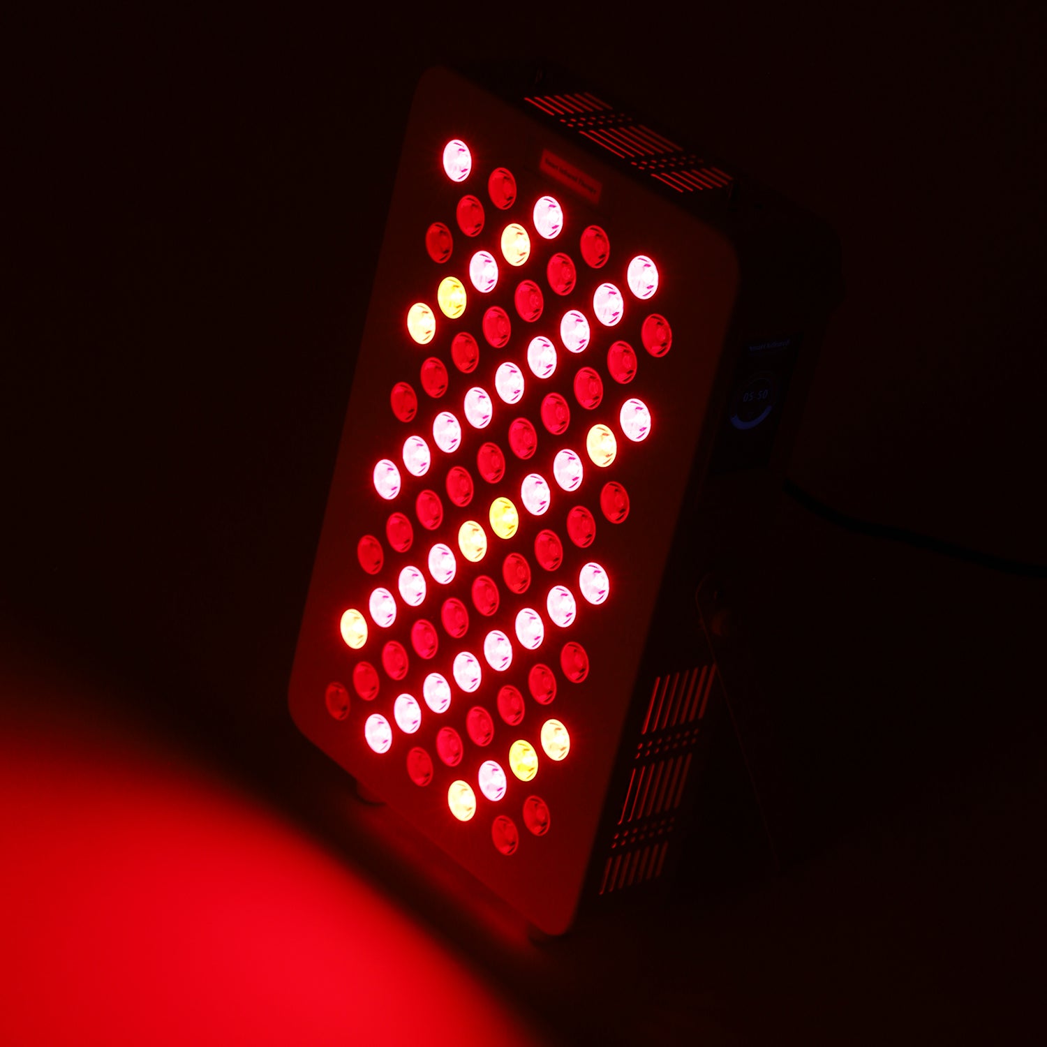 Panel in use, red and near-infrared light beams active in dark background.