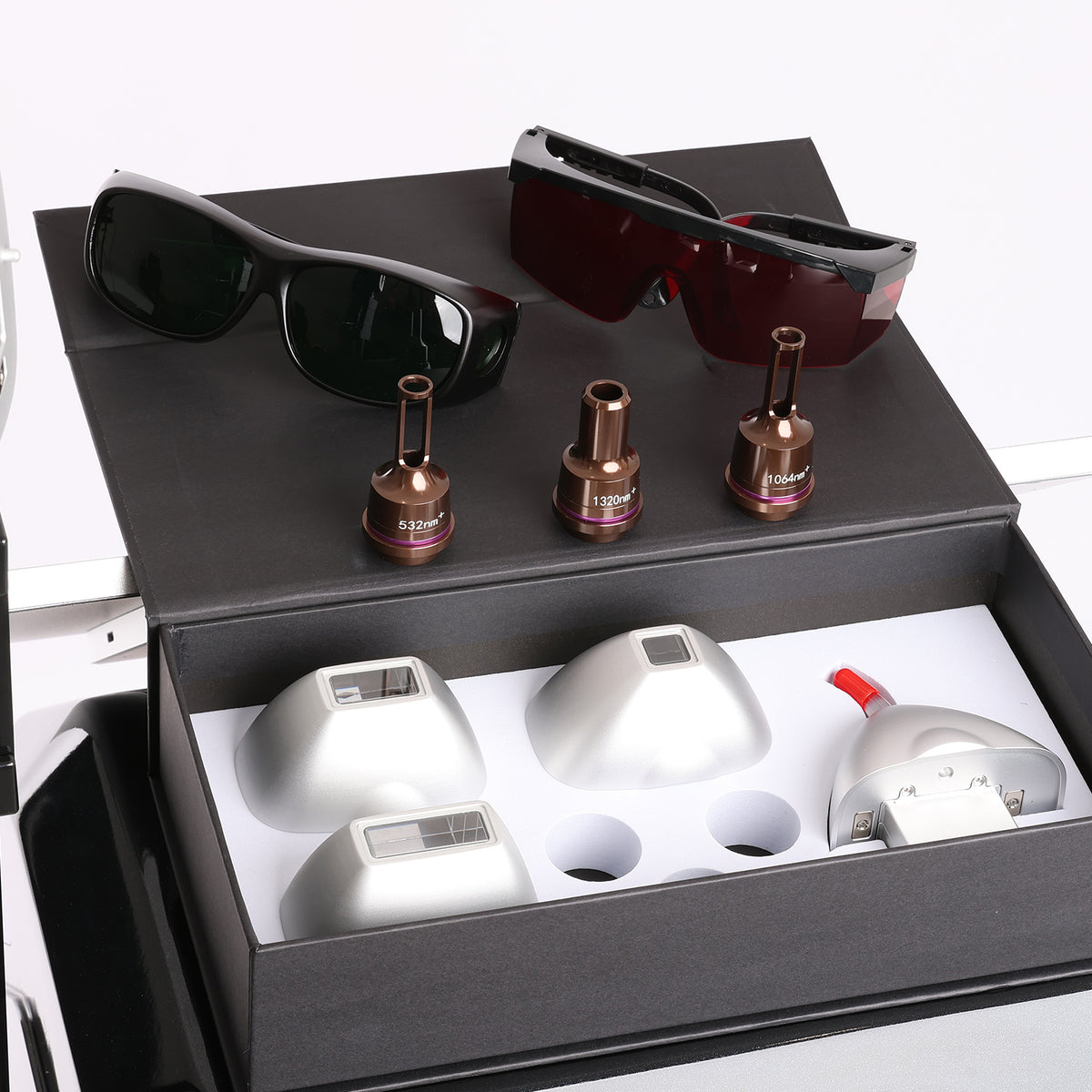 A boxed set of laser hair removal devices and accessories displayed on a white background. 