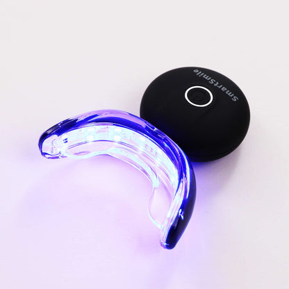 SmartSmile LED tray glowing blue for accelerated teeth whitening treatment.