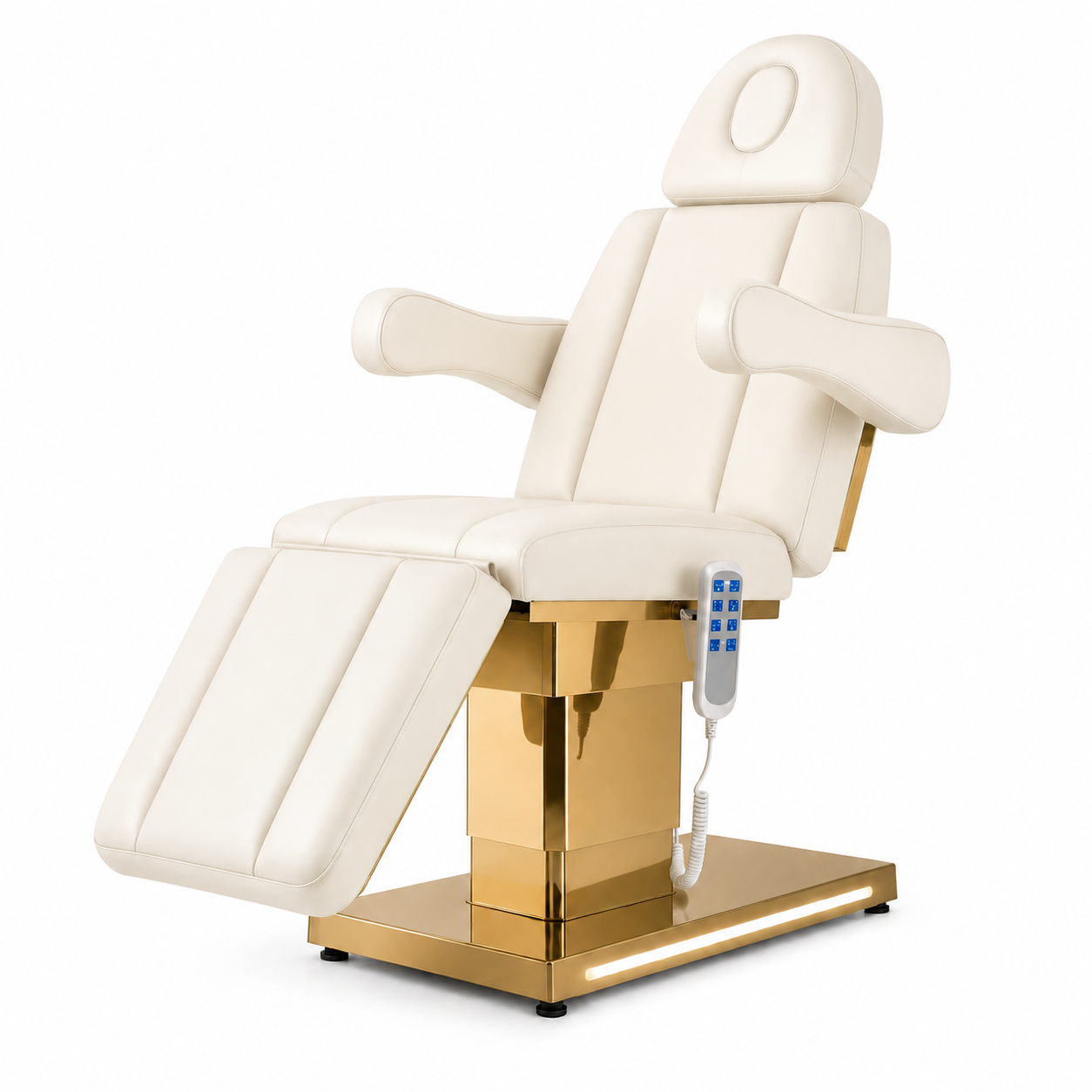 A modern cream leather treatment bed with a gold metallic base and armrest supports, featuring an adjustable footrest.
